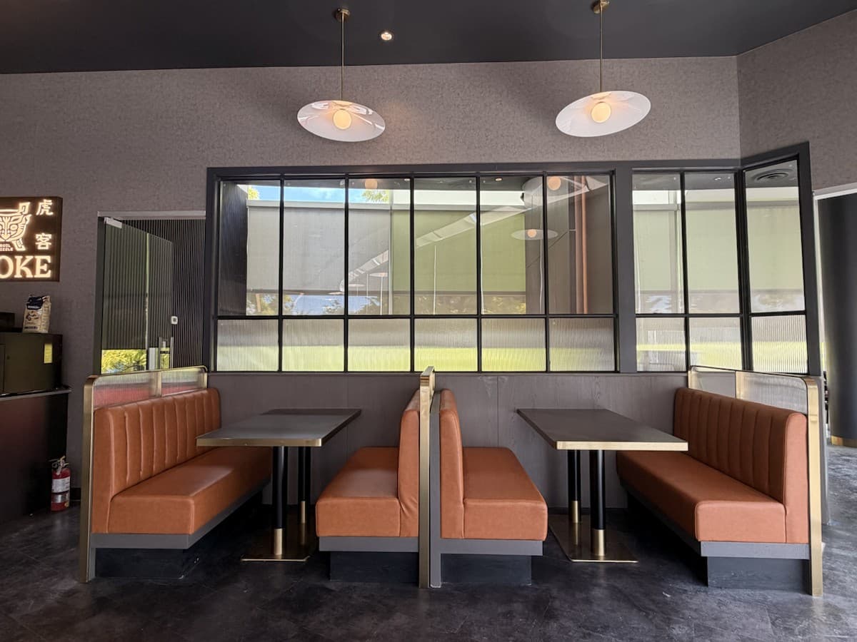 Dining-room decisions such as booth depth, aisle width, lighting, millwork and durable finishes can affect both guest experience and construction cost.